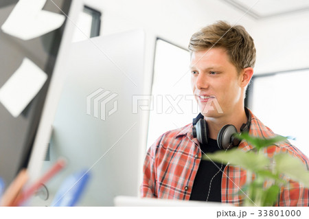 Young man working in office 33801000