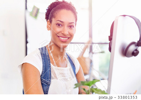 Portrait of smiling afro-american office worker sitting in offfice Portrait of smiling afro-american office worker sitting in offfice 33801353
