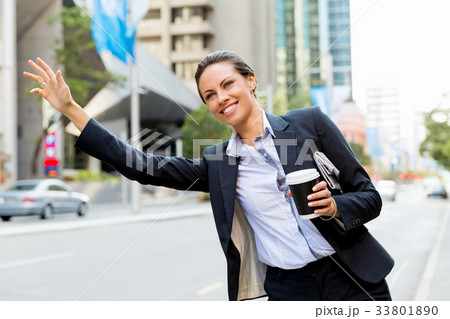 Portrait of business woman catching taxi Portrait of business woman catching taxi 33801890