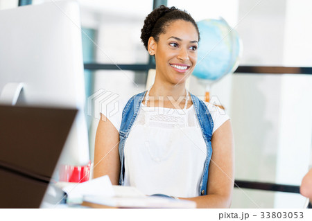Portrait of smiling afro-american office worker sitting in offfice Portrait of smiling afro-american office worker sitting in offfice 33803053