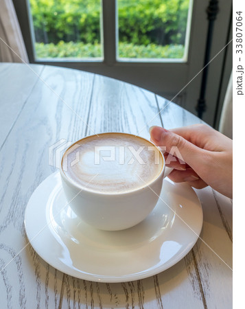 Latte in white cup as breakfast Latte in white cup as breakfast 33807064