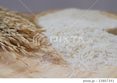 Paddy and white rice on wooden background. Paddy and white rice on wooden background. 33807341