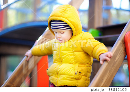 Happy little boy having fun on outdoor playground 33812106