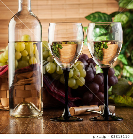 Bottle and glasses of white wine Bottle and glasses of white wine 33813116