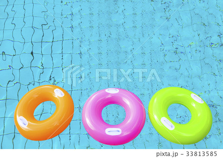 three colorful swimming pool rings on the water 33813585