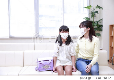 待合室でマスクをして順番を待つ母娘 33814812