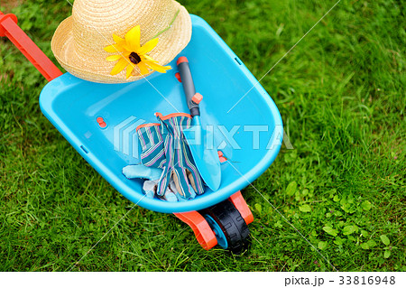 Toy wheelbarrow and garden tools. 33816948