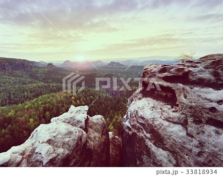 Morning view over crack edge into forest valley 33818934
