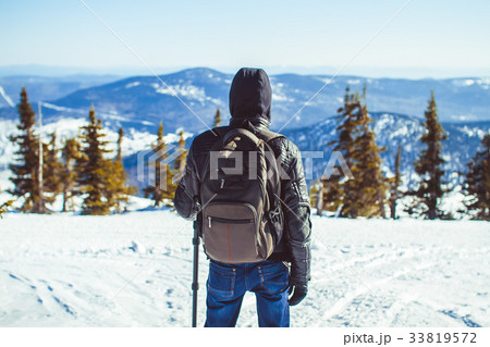 the guy is in the mountains in the winter 33819572