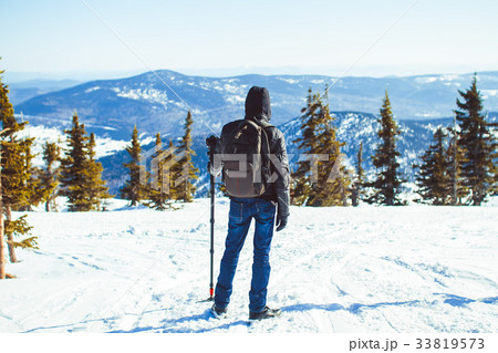 the guy is in the mountains in the winter the guy is in the mountains in the winter 33819573