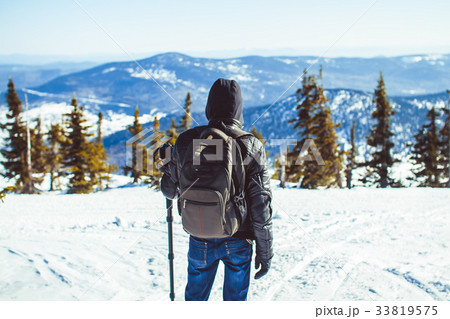 the guy is in the mountains in the winter the guy is in the mountains in the winter 33819575