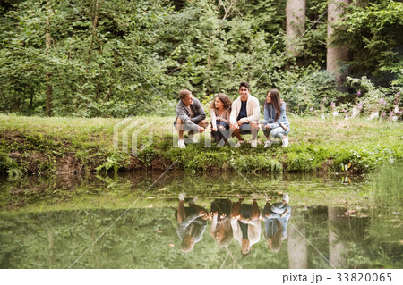 Teenagers at the lake. Summer vacation. 33820065