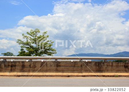 Side of road with tree and clouds sky background. 33822052