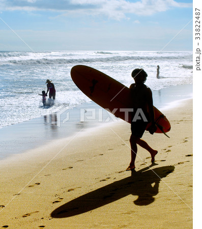 Silhouette of surfer on beach 33822487