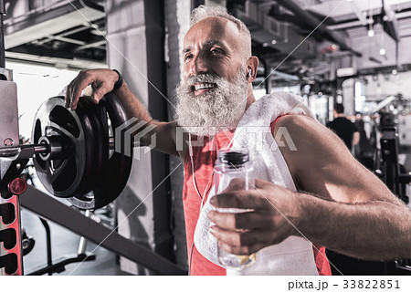 Cheerful stylish man is standing in modern gym Cheerful stylish man is standing in modern gym 33822851