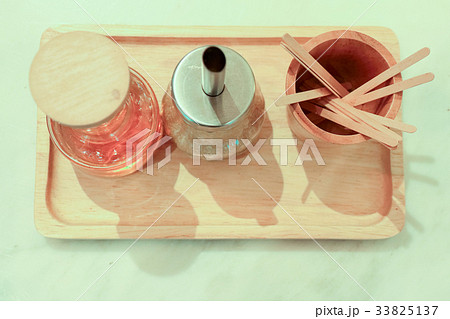 stick at wooden cup with syrup and sugar stick at wooden cup with syrup and sugar 33825137