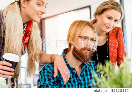 Young office workers discussing Young office workers discussing 33828315