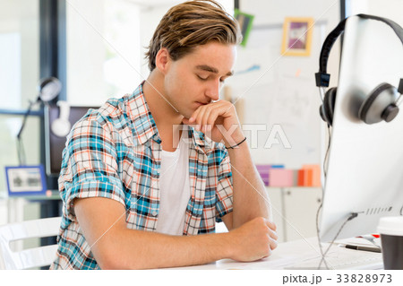 Young man working in office Young man working in office 33828973