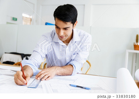 Young man architect in office Young man architect in office 33830180