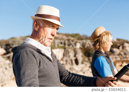 Senior man fishing with his grandson Senior man fishing with his grandson 33834011