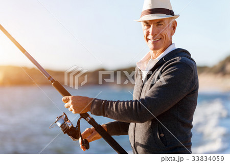 Senior man fishing at sea side 33834059