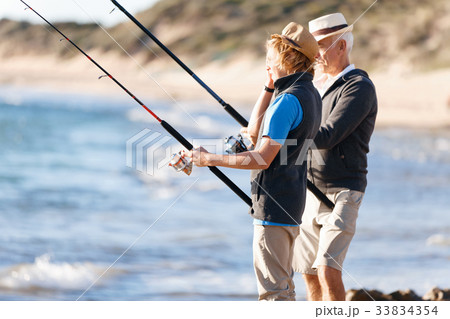 Senior man fishing with his grandson 33834354