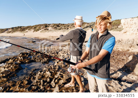 Senior man fishing with his grandson Senior man fishing with his grandson 33834555