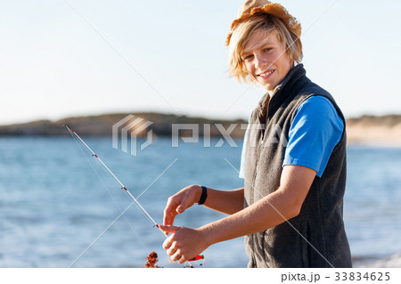 Teenage boy fishing at sea Teenage boy fishing at sea 33834625