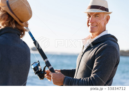 Senior man fishing with his grandson Senior man fishing with his grandson 33834712