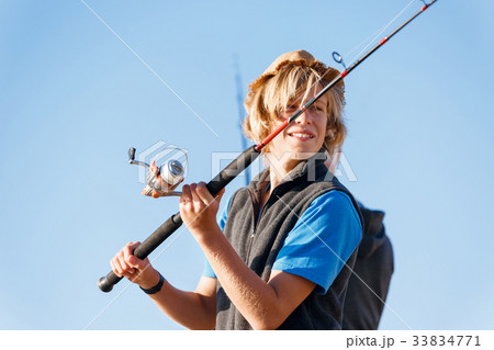 Teenage boy fishing at sea Teenage boy fishing at sea 33834771