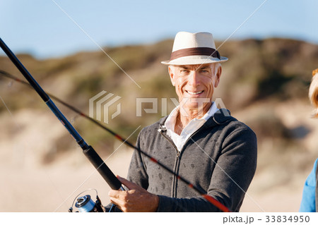 Senior man fishing at sea side 33834950