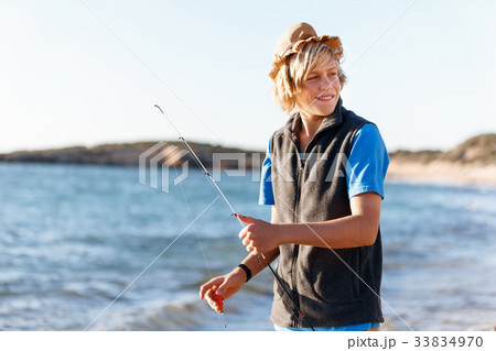 Teenage boy fishing at sea Teenage boy fishing at sea 33834970