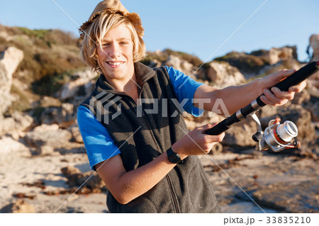 Teenage boy fishing at sea Teenage boy fishing at sea 33835210
