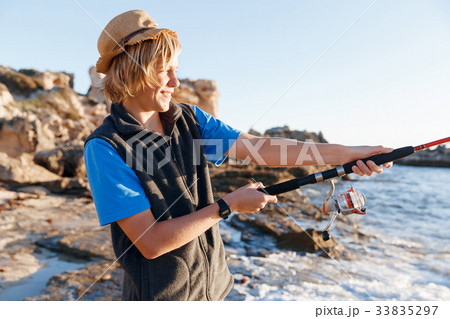 Teenage boy fishing at sea 33835297