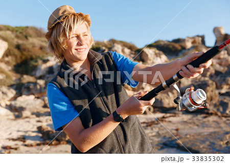 Teenage boy fishing at sea 33835302