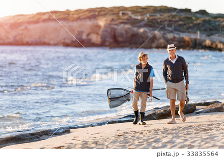 Senior man fishing with his grandson 33835564