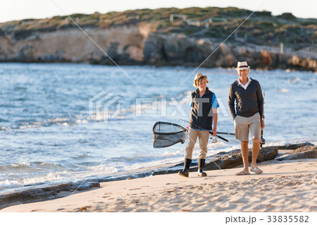 Senior man fishing with his grandson Senior man fishing with his grandson 33835582