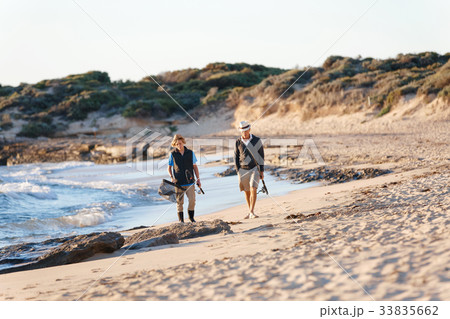 Senior man fishing with his grandson Senior man fishing with his grandson 33835662