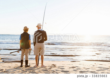 Senior man fishing with his grandson Senior man fishing with his grandson 33835663