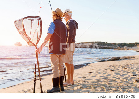 Senior man fishing with his grandson 33835709