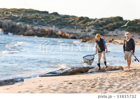 Senior man fishing with his grandson 33835732
