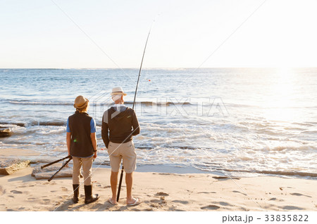 Senior man fishing with his grandson 33835822