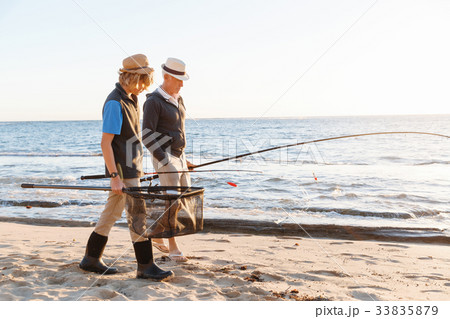 Senior man fishing with his grandson Senior man fishing with his grandson 33835879