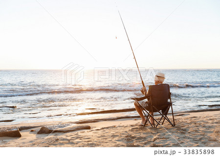 Senior man fishing at sea side Senior man fishing at sea side 33835898