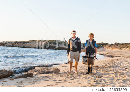 Senior man fishing with his grandson Senior man fishing with his grandson 33835899