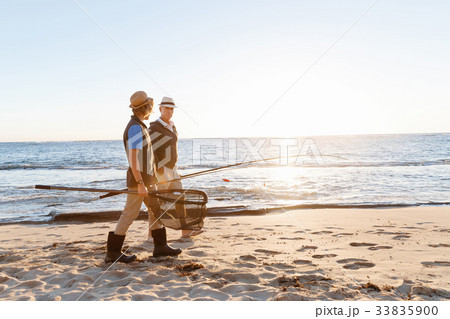 Senior man fishing with his grandson Senior man fishing with his grandson 33835900