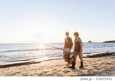 Senior man fishing with his grandson 33835941