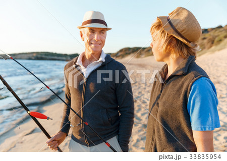 Senior man fishing with his grandson Senior man fishing with his grandson 33835954