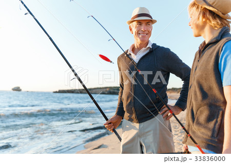 Senior man fishing with his grandson 33836000