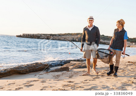 Senior man fishing with his grandson Senior man fishing with his grandson 33836049